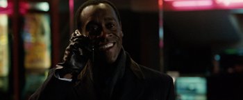 Movie still from “Reign Over Me” (2007), directed by Mike Binder – A man smiles while talking on a cell phone; Close Up shot, Over the shoulder angle