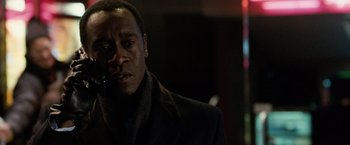 Movie still from “Reign Over Me” (2007), directed by Mike Binder – A man with a pipe in his mouth and wearing a coat; Close Up shot, Over the shoulder angle