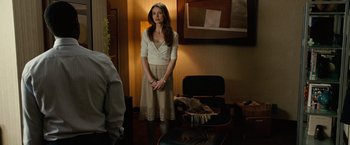 Movie still from “Reign Over Me” (2007), directed by Mike Binder – A woman standing in front of a chair in a living room; Medium shot, Over the shoulder angle