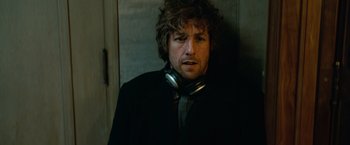 Movie still from “Reign Over Me” (2007), directed by Mike Binder – A man wearing a black jacket and a silver tie; Close Up shot, Low angle