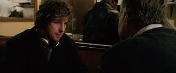 Movie still from “Reign Over Me” (2007), directed by Mike Binder – A man sitting next to another man in a restaurant; Close Up shot, Over the shoulder angle