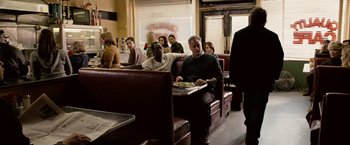 Movie still from “Reign Over Me” (2007), directed by Mike Binder – A group of people sitting at a table in a restaurant; Wide shot, Over the shoulder angle
