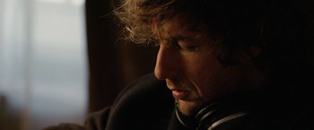 Movie still from “Reign Over Me” (2007), directed by Mike Binder – A person wearing headphones; Close Up shot, Over the shoulder angle