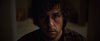 Movie still from “Reign Over Me” (2007), directed by Mike Binder – A person wearing a plaid shirt; Close Up shot, Low angle