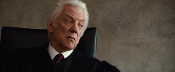 Movie still from “Reign Over Me” (2007), directed by Mike Binder – An older man sitting in an office chair; Close Up shot, Low angle