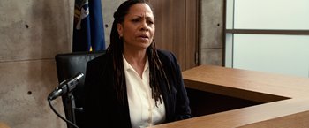 Movie still from “Reign Over Me” (2007), directed by Mike Binder – A woman sitting at a table in front of a judge; Close Up shot, Over the shoulder angle