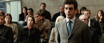 Movie still from “Reign Over Me” (2007), directed by Mike Binder – A man in a suit and tie in front of a group of people; Close Up shot, Over the shoulder angle
