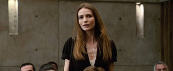 Movie still from “Reign Over Me” (2007), directed by Mike Binder – A beautiful woman with long brown hair wearing a black shirt; Close Up shot, Over the shoulder angle