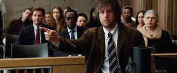 Movie still from “Reign Over Me” (2007), directed by Mike Binder – A man in a brown jacket and a blue and white striped neck tie; Medium shot, Over the shoulder angle