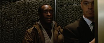 Movie still from “Reign Over Me” (2007), directed by Mike Binder – A man sitting on a train looking at the camera; Close Up shot, Over the shoulder angle