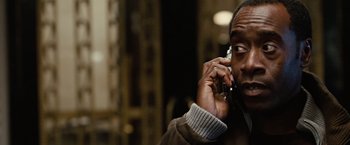 Movie still from “Reign Over Me” (2007), directed by Mike Binder – A man talking on a cell phone while wearing a jacket; Close Up shot, Over the shoulder angle