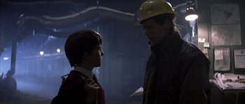 Movie still from “Reign of Fire” (2002), directed by Rob Bowman – A man and a boy wearing a hard hat; Close Up shot, Over the shoulder angle