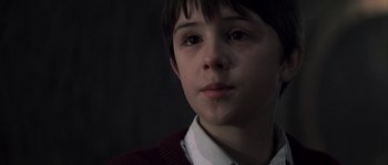 Movie still from “Reign of Fire” (2002), directed by Rob Bowman – A young boy is looking into the distance; Close Up shot, Over the shoulder angle