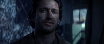 Movie still from “Reign of Fire” (2002), directed by Rob Bowman – A person wearing a jacket; Close Up shot, Over the shoulder angle