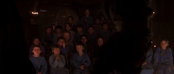 Movie still from “Reign of Fire” (2002), directed by Rob Bowman – A group of children sitting in front of an audience; Medium shot, High angle