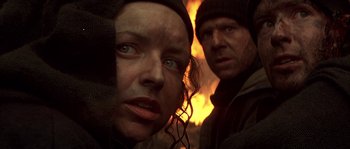 Movie still from “Reign of Fire” (2002), directed by Rob Bowman – A woman and a man standing next to each other in front of a fire; Close Up shot, Low angle