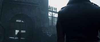 Movie still from “Reign of Fire” (2002), directed by Rob Bowman – A group of people standing on a bridge; Wide shot, Low angle