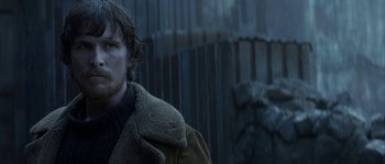 Movie still from “Reign of Fire” (2002), directed by Rob Bowman – A person wearing a jacket; Close Up shot, Over the shoulder angle