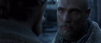 Movie still from “Reign of Fire” (2002), directed by Rob Bowman – A man with a long beard is looking at another man with a long beard; Close Up shot, Over the shoulder angle