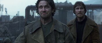 Movie still from “Reign of Fire” (2002), directed by Rob Bowman – A person wearing a jacket; Close Up shot, Low angle