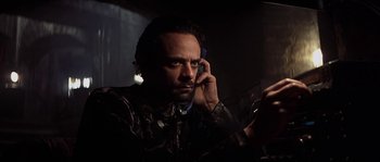 Movie still from “Reign of Fire” (2002), directed by Rob Bowman – A man is talking on a cell phone in the dark; Close Up shot, Low angle