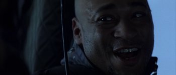 Movie still from “Reign of Fire” (2002), directed by Rob Bowman – A man's face while holding an umbrella; Close Up shot, Low angle