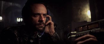 Movie still from “Reign of Fire” (2002), directed by Rob Bowman – A person talking on a cell phone; Close Up shot, Low angle