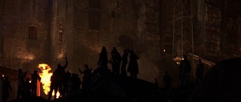 Movie still from “Reign of Fire” (2002), directed by Rob Bowman – A group of people standing on top of a rock; Extreme Wide shot, Low angle