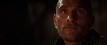 Movie still from “Reign of Fire” (2002), directed by Rob Bowman – A person with a beard; Close Up shot, Low angle