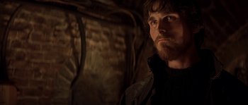 Movie still from “Reign of Fire” (2002), directed by Rob Bowman – A person with a beard; Close Up shot, Low angle
