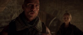 Movie still from “Reign of Fire” (2002), directed by Rob Bowman – A person wearing a scarf; Close Up shot, Low angle