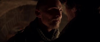 Movie still from “Reign of Fire” (2002), directed by Rob Bowman – A man with a beard is looking into the distance; Close Up shot, Over the shoulder angle