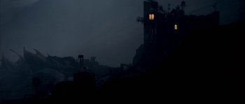 Movie still from “Reign of Fire” (2002), directed by Rob Bowman – A building that has a window lit up at night; Extreme Wide shot, Low angle