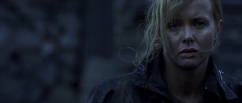 Movie still from “Reign of Fire” (2002), directed by Rob Bowman – A person with long blonde hair; Close Up shot, Over the shoulder angle