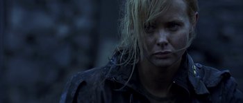 Movie still from “Reign of Fire” (2002), directed by Rob Bowman – A person wearing a black jacket; Close Up shot, Over the shoulder angle