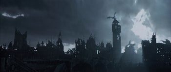 Movie still from “Reign of Fire” (2002), directed by Rob Bowman – A clock tower in the middle of a dark city; Extreme Wide shot, Low angle