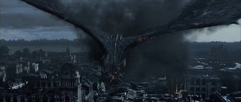 Movie still from “Reign of Fire” (2002), directed by Rob Bowman – An image of a dragon in the middle of a city; Extreme Wide shot, High angle