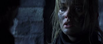 Movie still from “Reign of Fire” (2002), directed by Rob Bowman – A person with makeup on her face; Close Up shot, Over the shoulder angle