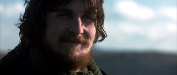 Movie still from “Reign of Fire” (2002), directed by Rob Bowman – A person with a beard; Close Up shot, Over the shoulder angle