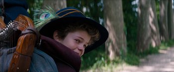 Movie still from “Remi, Nobody's Boy” (2018), directed by Antoine Blossier – A young boy wearing a hat and a scarf; Close Up shot, Over the shoulder angle