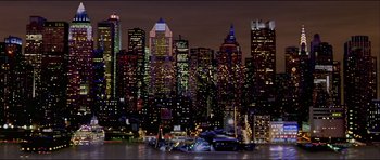 Movie still from “Renaissance” (2006), directed by Christian Volckman – A city skyline at night with lights reflecting off the water; Extreme Wide shot, High angle