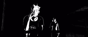 Movie still from “Renaissance” (2006), directed by Christian Volckman – A black and white image of a man smoking a cigarette; Medium shot, Low angle