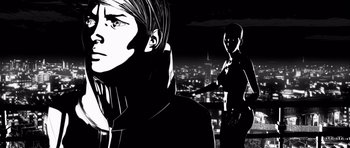 Movie still from “Renaissance” (2006), directed by Christian Volckman – A black - and - white image of a man and a woman in front of a city skyline at night; Close Up shot, Low angle