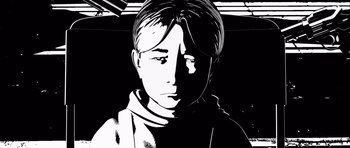 Movie still from “Renaissance” (2006), directed by Christian Volckman – A black and white image of a man in a sweater; Close Up shot, Low angle