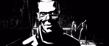 Movie still from “Renaissance” (2006), directed by Christian Volckman – A black and white image of a man wearing glasses; Close Up shot, Low angle