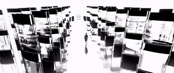 Movie still from “Renaissance” (2006), directed by Christian Volckman – A person walking through a room filled with chairs; Extreme Wide shot, Low angle