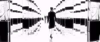 Movie still from “Renaissance” (2006), directed by Christian Volckman – A black and white photo of a woman walking down a hallway; Wide shot, Low angle