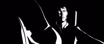 Movie still from “Renaissance” (2006), directed by Christian Volckman – A black and white image of a man in a black shirt; Close Up shot, Low angle