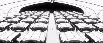 Movie still from “Renaissance” (2006), directed by Christian Volckman – Two people are standing in a room with many rows of buses in it; Extreme Wide shot, High angle