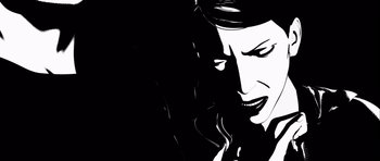 Movie still from “Renaissance” (2006), directed by Christian Volckman – A black - and - white image of a woman talking on a phone; Extreme Close Up shot, Low angle